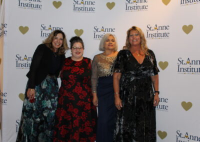 Four women posing for a photo at a science institute event.