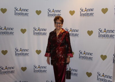 A woman standing on a red carpet.