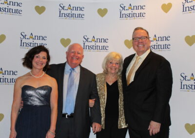 Four people posing for a photo at the san antonio institute.