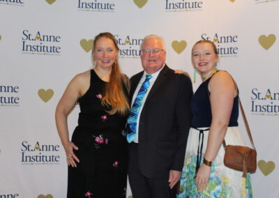 Three people posing for a picture.