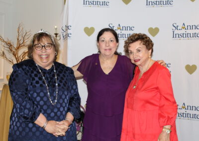 Three women standing next to each other.