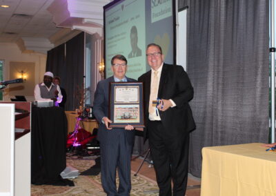 A man holding a plaque.