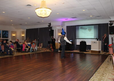 A man is standing on a wooden floor.