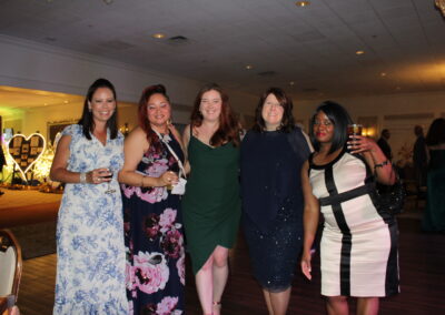 A group of women posing for a photo at a party.