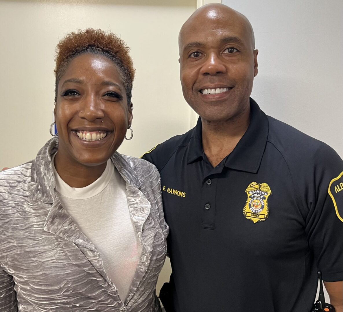 A man and a woman smiling at the camera